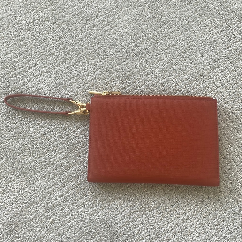 Dagne Dover clutch in a burnt orange color